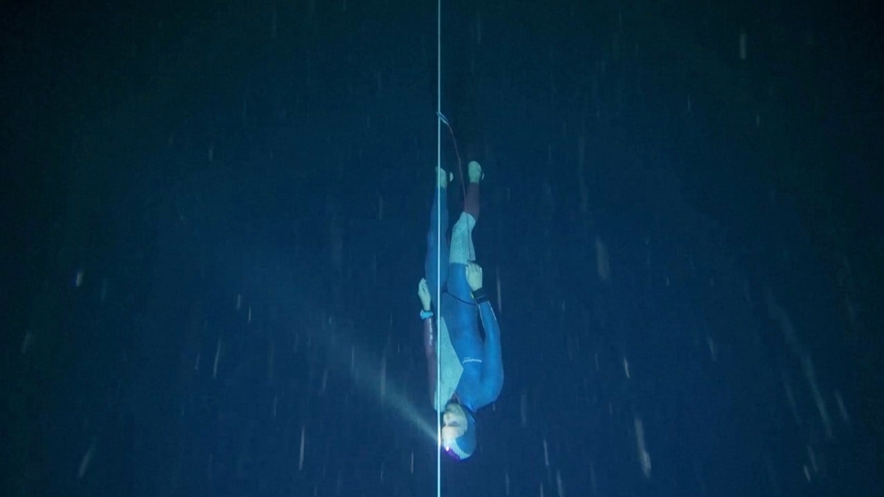 French freediver breaks world record with 120m-deep dive